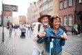 Portrait of happy senior couple tourists riding scooter together outdoors in town Royalty Free Stock Photo