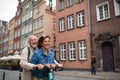 Portrait of happy senior couple tourists riding scooter together outdoors in town Royalty Free Stock Photo