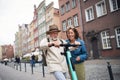 Portrait of happy senior couple tourists riding scooter together outdoors in town Royalty Free Stock Photo