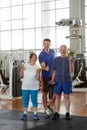 Portrait of happy senior couple with trainer at gym. Royalty Free Stock Photo