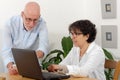 Portrait of a happy senior couple using laptop Royalty Free Stock Photo