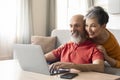 Portrait Of Happy Senior Couple Using Laptop Together At Home Royalty Free Stock Photo