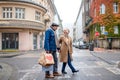 Happy senior couple walking outdoors on street in city, carrying shopping bags. Royalty Free Stock Photo