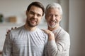 Portrait of happy senior father and adult son hugging Royalty Free Stock Photo