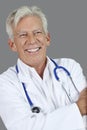 Portrait of happy senior male doctor over gray background Royalty Free Stock Photo