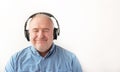 Portrait happy of senior man in headphones listening to music keeping eyes closed. Relaxing music time. Closeup Royalty Free Stock Photo