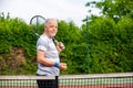 Portrait of happy senior man before his tennis match, sport concept