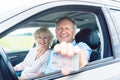 Portrait of a happy senior man showing his driving license while Royalty Free Stock Photo