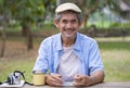 portrait happy senior man sitting in national park Royalty Free Stock Photo