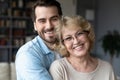 Portrait of happy senior mom and adult son hugging Royalty Free Stock Photo