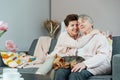 Portrait of happy senior 70s mother, adult neutral gender daughter and Yorkshire terriers dog hugging. Happy family Royalty Free Stock Photo