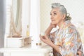 Portrait of happy senior woman applying makeup Royalty Free Stock Photo