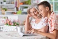 Happy senior woman with boy using using tablet at home Royalty Free Stock Photo