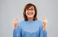 Portrait of happy senior woman celebrating triumph