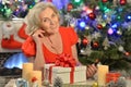 Portrait of happy senior woman with Christmas present Royalty Free Stock Photo