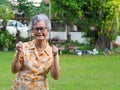 Portrait of happy senior woman clenching fists. Excited for success with arms raised celebrating victory smiling Royalty Free Stock Photo