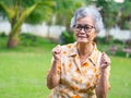 Portrait of happy senior woman clenching fists excited for success with arms raised celebrating victory smiling while standing Royalty Free Stock Photo