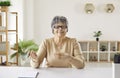 Portrait of happy senior woman during conference call, webinar or online work meeting Royalty Free Stock Photo