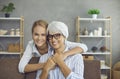 Portrait of happy senior woman with her daughter or granddaughter on sofa at home Royalty Free Stock Photo