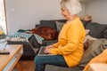 Portrait of happy senior woman looking at camera at home. Successful old lady laughing and working at home. Beautiful Royalty Free Stock Photo