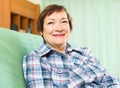 Portrait of happy senior woman relaxing in couch Royalty Free Stock Photo
