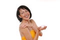 Portrait of happy senior woman using body lotion