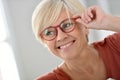 Portrait of happy senior woman wearing red eyeglasses Royalty Free Stock Photo