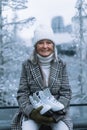 Portrait of happy senior woman in winter at outdoor ice skating rink. Royalty Free Stock Photo