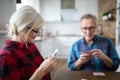 Happy senior woman playing cards with her husband Royalty Free Stock Photo