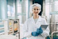 Portrait happy senior women worker in drinking water plant clean hygiene uniform stading smiling Royalty Free Stock Photo