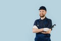 Portrait of a happy service worker with hands crossed, dressed in uniform