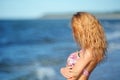 Portrait of happy girl in pink bikini posing against sea Royalty Free Stock Photo