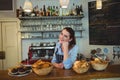 Portrait of happy shop owner at counter in coffee house Royalty Free Stock Photo