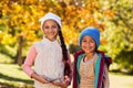 Portrait of happy siblings standing at park Royalty Free Stock Photo