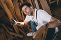 Portrait happy smile carpenter man in wooden furniture in workshop. Male worker 40s professional high skill joiner authentic real Royalty Free Stock Photo