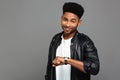 Portrait of a happy smiling african man in leather jacket Royalty Free Stock Photo