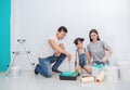 Portrait of happy smiling asian family renovating painting wall house.