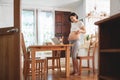 Portrait of Happy Smiling Asian pregnant woman standing showing her belly using video chatting with family on laptop Royalty Free Stock Photo