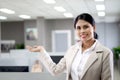 Portrait happy smiling Asian woman officer worker standing, pretending to hold something or welcoming to her office, confident Royalty Free Stock Photo