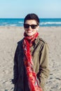 Portrait of happy smiling beautiful Caucasian white brunette woman with short hair in green jacket, red scarf and sunglasses Royalty Free Stock Photo