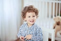 Portrait of happy smiling beautiful little boy in babyroom - checked shirt