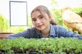 Portrait of happy smiling beautiful teenage girl with dental braces wearing casual clothes, young farmer seedling and caring Royalty Free Stock Photo