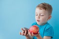 Portrait happy, smiling boy choosing junk food. Healthy versus unhealthy food. Healthy vs unhealthy eating, teenager choosing Royalty Free Stock Photo