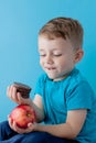 Portrait happy, smiling boy choosing junk food. Healthy versus unhealthy food. Healthy vs unhealthy eating, teenager choosing Royalty Free Stock Photo