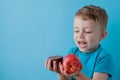 Portrait happy, smiling boy choosing junk food. Healthy versus unhealthy food. Healthy vs unhealthy eating, teenager choosing Royalty Free Stock Photo