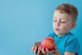 Portrait happy, smiling boy choosing junk food. Healthy versus unhealthy food. Healthy vs unhealthy eating, teenager choosing Royalty Free Stock Photo