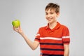 Portrait of happy smiling boy holding green apple Royalty Free Stock Photo