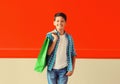 Happy smiling boy teenager with shopping bag in the city on red background Royalty Free Stock Photo