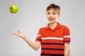 Portrait of happy smiling boy throwing green apple Royalty Free Stock Photo