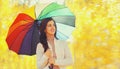 Portrait of happy smiling brunette woman with colorful umbrella in autumn park Royalty Free Stock Photo